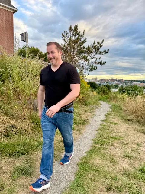 Therapist walking with a client in a scenic outdoor setting